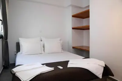 a bedroom with a white bed with two towels on it at Gazi Boutique Apartment 2 in Athens