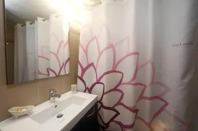 a bathroom with a sink and a shower curtain at Gazi Boutique Apartment 2 in Athens