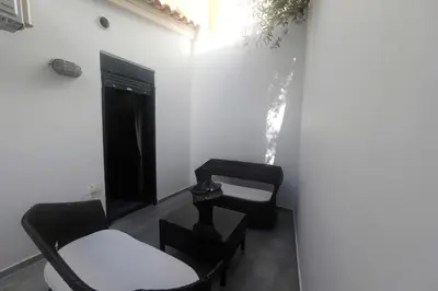 a living room with two chairs and a table at Gazi Boutique Apartment 2 in Athens
