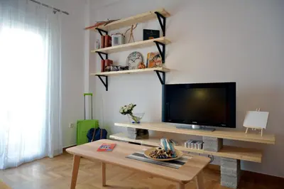a living room with a tv and a coffee table at Hidden Gem next to the Acropolis in Athens