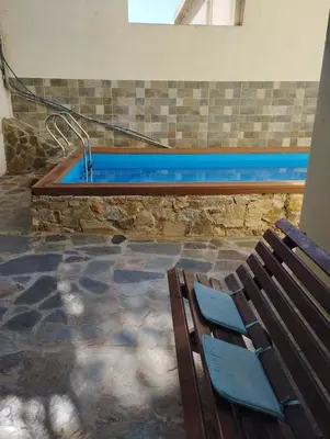 a bench sitting in front of a swimming pool at Panoramic Voula's View Apartment in Athens