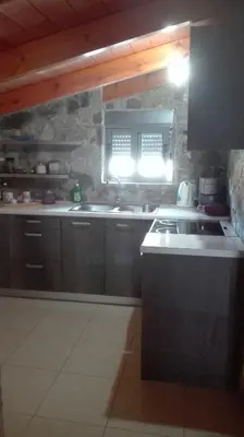 a kitchen with a sink and a stove at Panoramic Voula's View Apartment in Athens