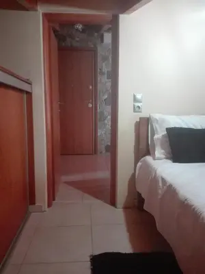 a bedroom with a bed and a door to a hallway at Panoramic Voula's View Apartment in Athens