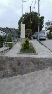 a stone walkway in a parking lot at Panoramic Voula's View Apartment in Athens