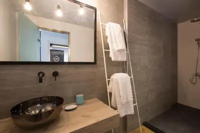 a bathroom with a sink and a mirror at Pi Athens in Athens