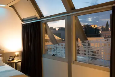 a bedroom with a window with a view of a city at Pi Athens in Athens