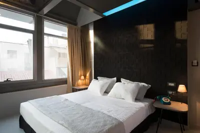 a bedroom with a large white bed with a window at Pi Athens in Athens