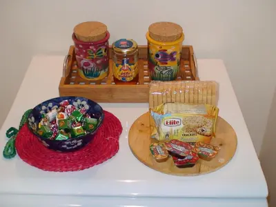 a table with a bowl of candy and a bowl of peanuts at Oro's Stylish Kolonaki Flats Next to Metro & Museums in Athens