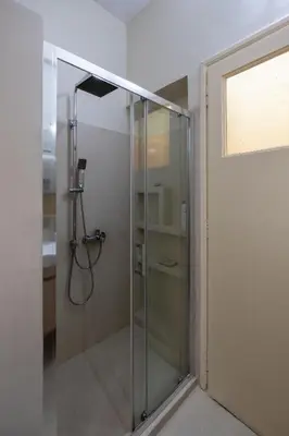 a shower with a glass door in a bathroom at Oro's Stylish Kolonaki Flats Next to Metro & Museums in Athens