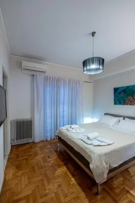 a bedroom with a large bed and a window at Oro's Stylish Kolonaki Flats Next to Metro & Museums in Athens