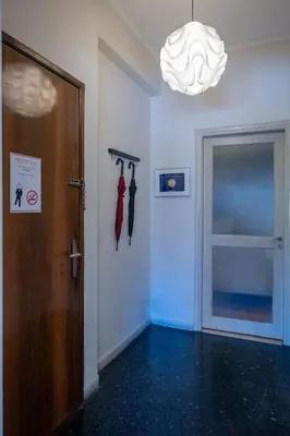 a hallway with a door and a chandelier at Oro's Stylish Kolonaki Flats Next to Metro & Museums in Athens