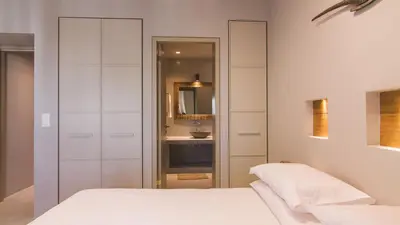 a bedroom with a bed and a bathroom with a sink at Acropolis Luxury Apartments in Athens