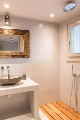 a bathroom with a sink and a mirror at Acropolis Luxury Apartments in Athens