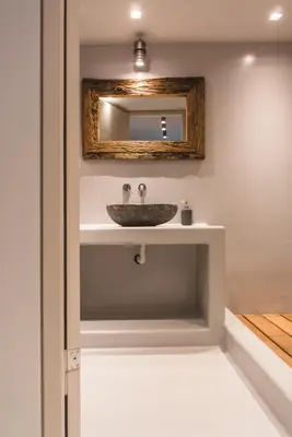 a bathroom with a sink and a mirror at Acropolis Luxury Apartments in Athens