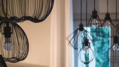 three chandeliers hanging from a wall with a window at Acropolis Luxury Apartments in Athens