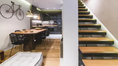 a kitchen and dining room with a table and stairs at Acropolis Luxury Apartments in Athens