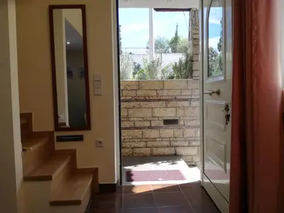 a door leading to a bathroom with a brick wall at Agapi's Two Levels Studio in Athens