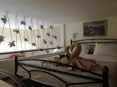 a bedroom with a bed with a stuffed animal on it at Agapi's Two Levels Studio in Athens