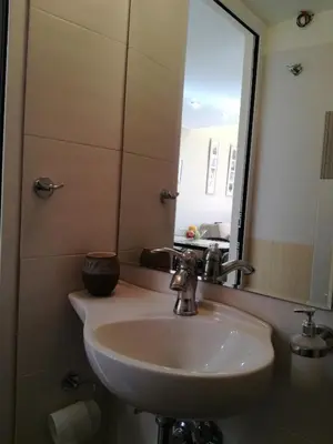 a bathroom with a sink and a mirror at Agapi's Two Levels Studio in Athens