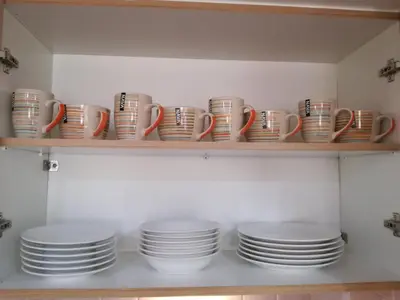 a shelf filled with plates and cups and saucers at Agapi's Two Levels Studio in Athens
