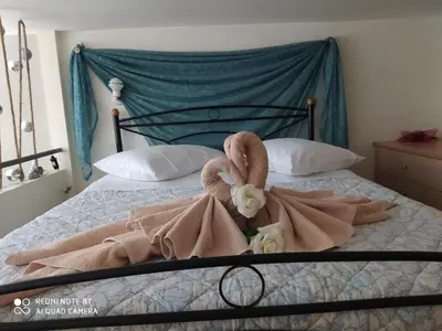 a bedroom with a bed with a towel on it at Agapi's Two Levels Studio in Athens
