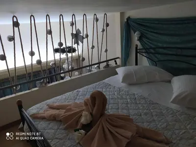 a bedroom with a bed with a towel on it at Agapi's Two Levels Studio in Athens