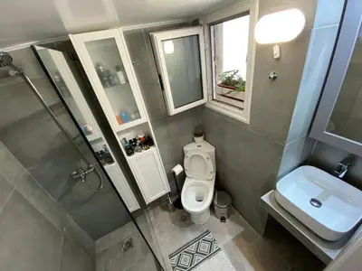 a small bathroom with a toilet and a sink at Plato's Academy Home in Athens