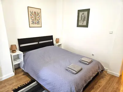 a bedroom with a bed with two towels on it at Plato's Academy Home in Athens