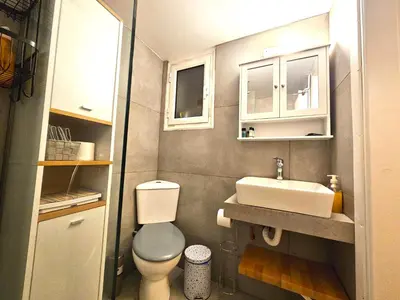 a small bathroom with a toilet and a sink at Plato's Academy Home in Athens