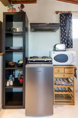 a kitchen with a stove and a microwave at Top Floor Studio Near Metro&View&200mbps in Athens