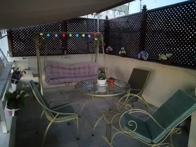 a balcony with a table and chairs and a couch at Top Floor Studio Near Metro&View&200mbps in Athens