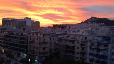 a view of a city at sunset with buildings at Top Floor Studio Near Metro&View&200mbps in Athens
