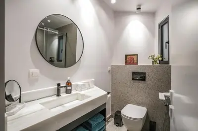 a bathroom with a sink and a mirror at ApArt Suite in Athens