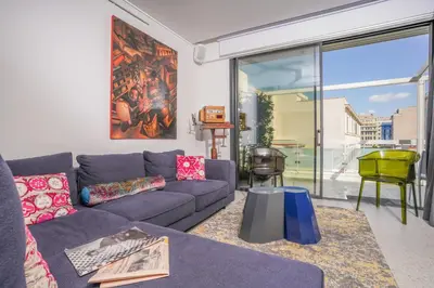 a living room with a couch and a large window at ApArt Suite in Athens
