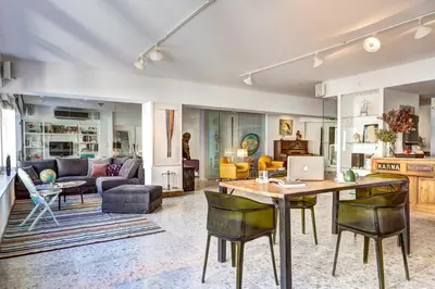 a kitchen and living room with a table and chairs at ApArt Suite in Athens
