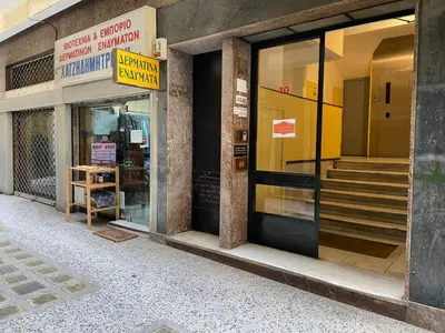 a store front of a building with a sign on the door at Lekka 10 Apartments in Athens
