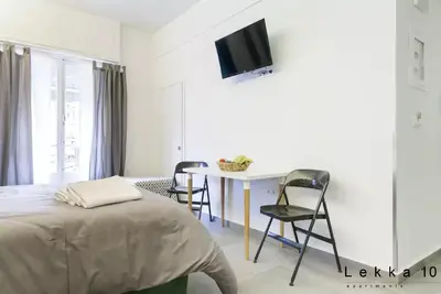 a bedroom with a bed and a table and chairs at Lekka 10 Apartments in Athens