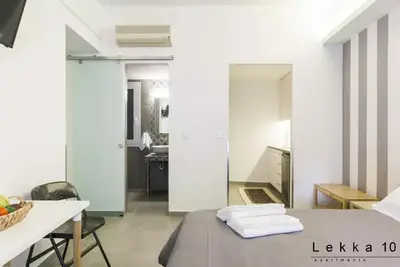 a room with a bed and a table and a kitchen at Lekka 10 Apartments in Athens