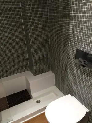 a bathroom with a toilet and a tiled shower at Captains 2-Bedroom Suite in Athens Nea Smyrni in Athens