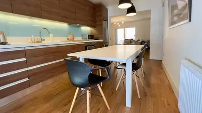 a kitchen with a white table and black chairs at Captains 2-Bedroom Suite in Athens Nea Smyrni in Athens