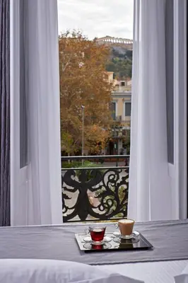 a tray with two cups on a table in front of a window at The Zillers Boutique Hotel in Athens