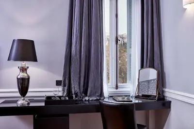 a desk with a mirror and a lamp next to a window at The Zillers Boutique Hotel in Athens