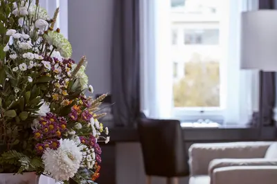 a vase of flowers in a living room with a window at The Zillers Boutique Hotel in Athens