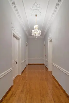 an empty room with white walls and a chandelier at The Zillers Boutique Hotel in Athens