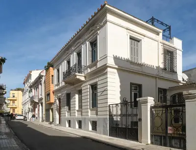 a white building on the side of a street at The White House in Plaka by JJ Hospitality in Athens