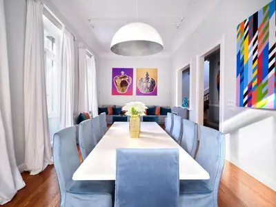 a dining room with a table and blue chairs at The White House in Plaka by JJ Hospitality in Athens