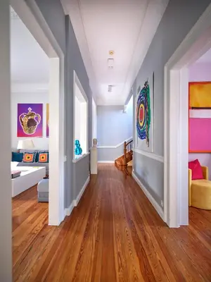 a living room with blue walls and wooden floors at The White House in Plaka by JJ Hospitality in Athens