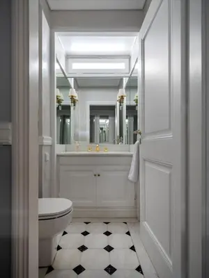 a bathroom with a toilet and a sink and a mirror at The White House in Plaka by JJ Hospitality in Athens