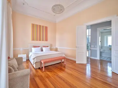 a bedroom with a bed and a couch at The White House in Plaka by JJ Hospitality in Athens