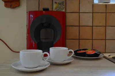 two cups and saucers sitting on a counter in a kitchen at Markella's House in Vravrona